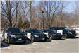 Four different police cruisers parked in a row